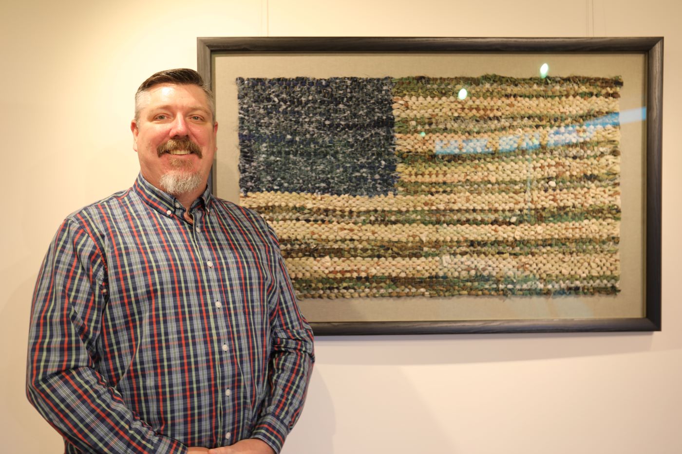 Art Instructor Jeffrey Stenbom with art piece he created